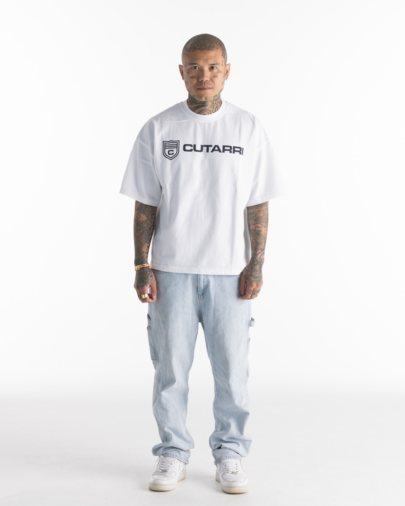Person wearing a white t-shirt with 'CUTARRI' logo on a white background